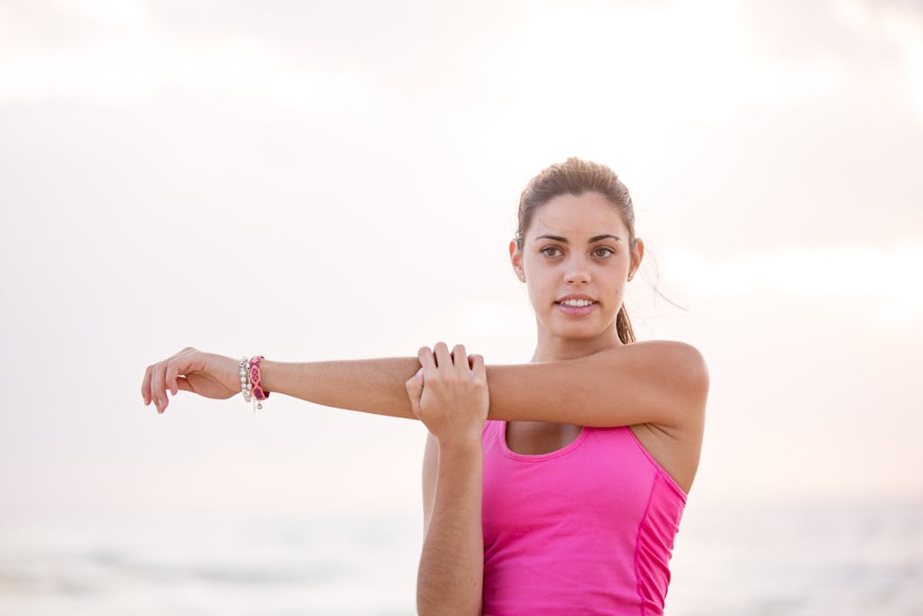 How Long Does It Take to Lose Weight? Young woman enjoying a relaxing stretch on a sunny Australian beach. Perfect for lifestyle and fitness themes.